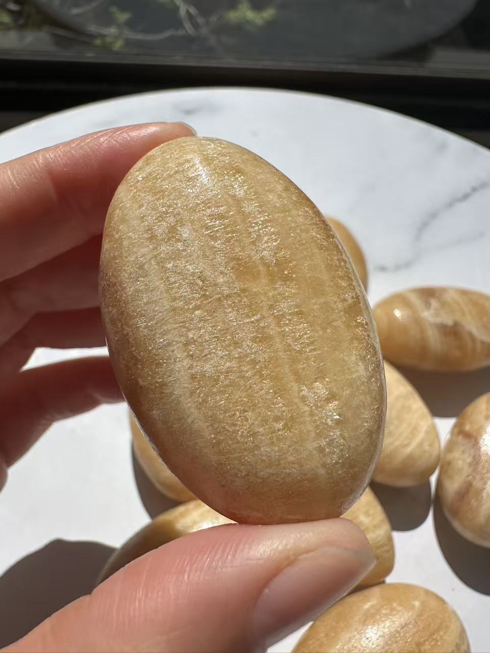 Yellow Calcite palm stone natural colour and banding detail