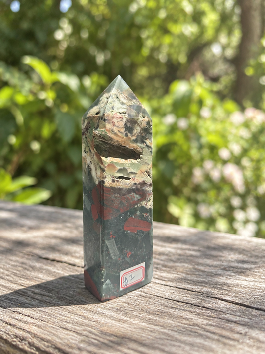 African bloodstone tower No.2, 472g and 16cm, showing its natural open cavities, pale mineral band and muted green-red markings