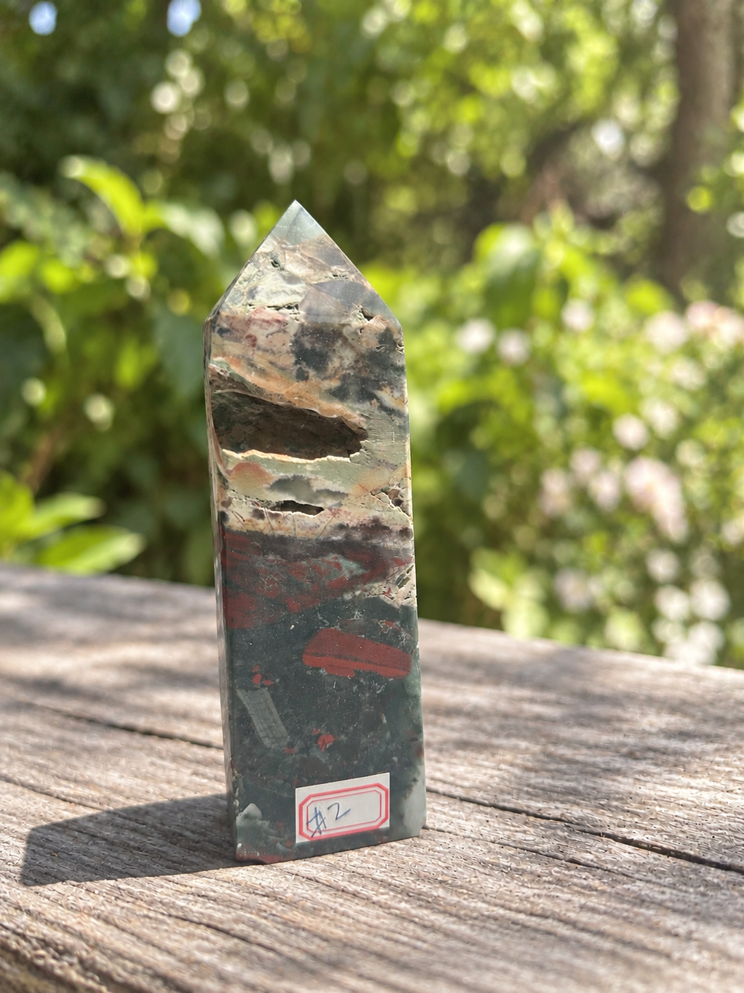 Front view of No.2 bloodstone tower showing the large natural cavity, smaller openings and red identification label