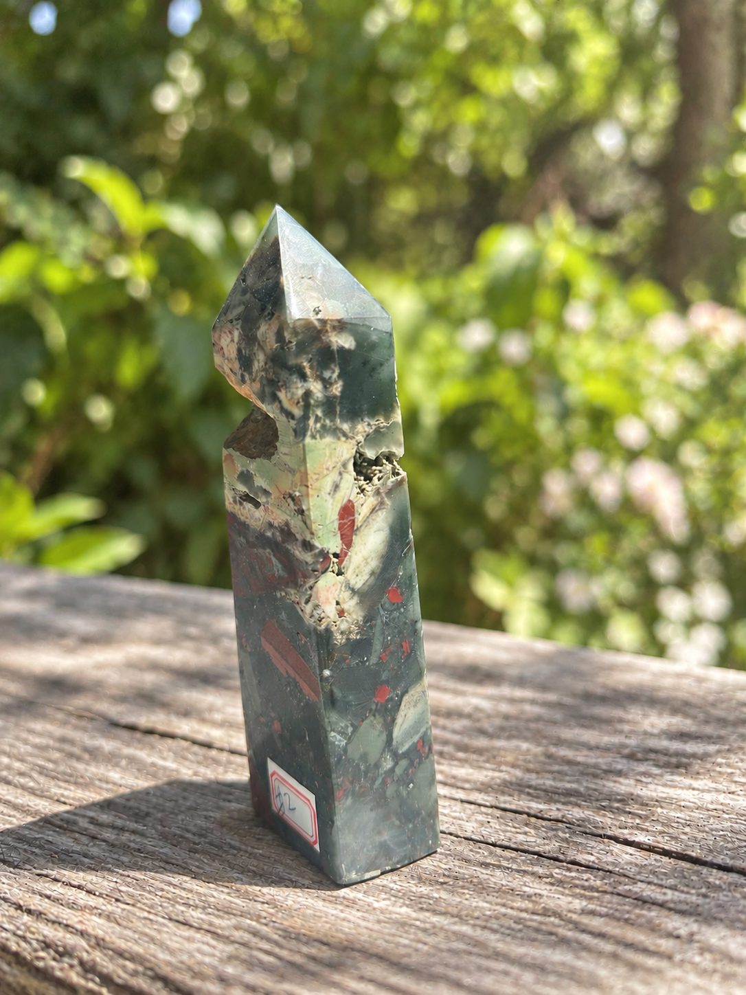 Three-quarter view of bloodstone tower No.2 with cream-coloured mineral areas, rough cavity edges and surface lines