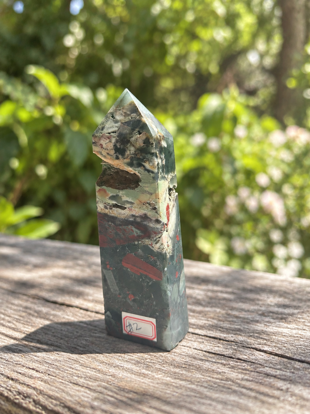 Labelled angled view of African bloodstone tower No.2 showing its large rough opening and green, cream and dark red pattern