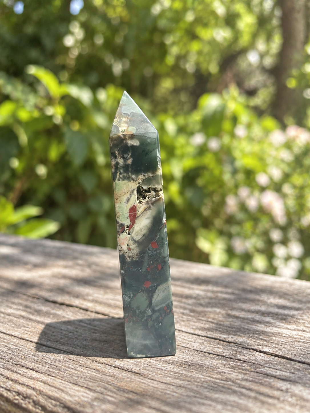 Side view of exact African bloodstone tower No.2 with its small natural cavity, pale diagonal mineral band and muted colours