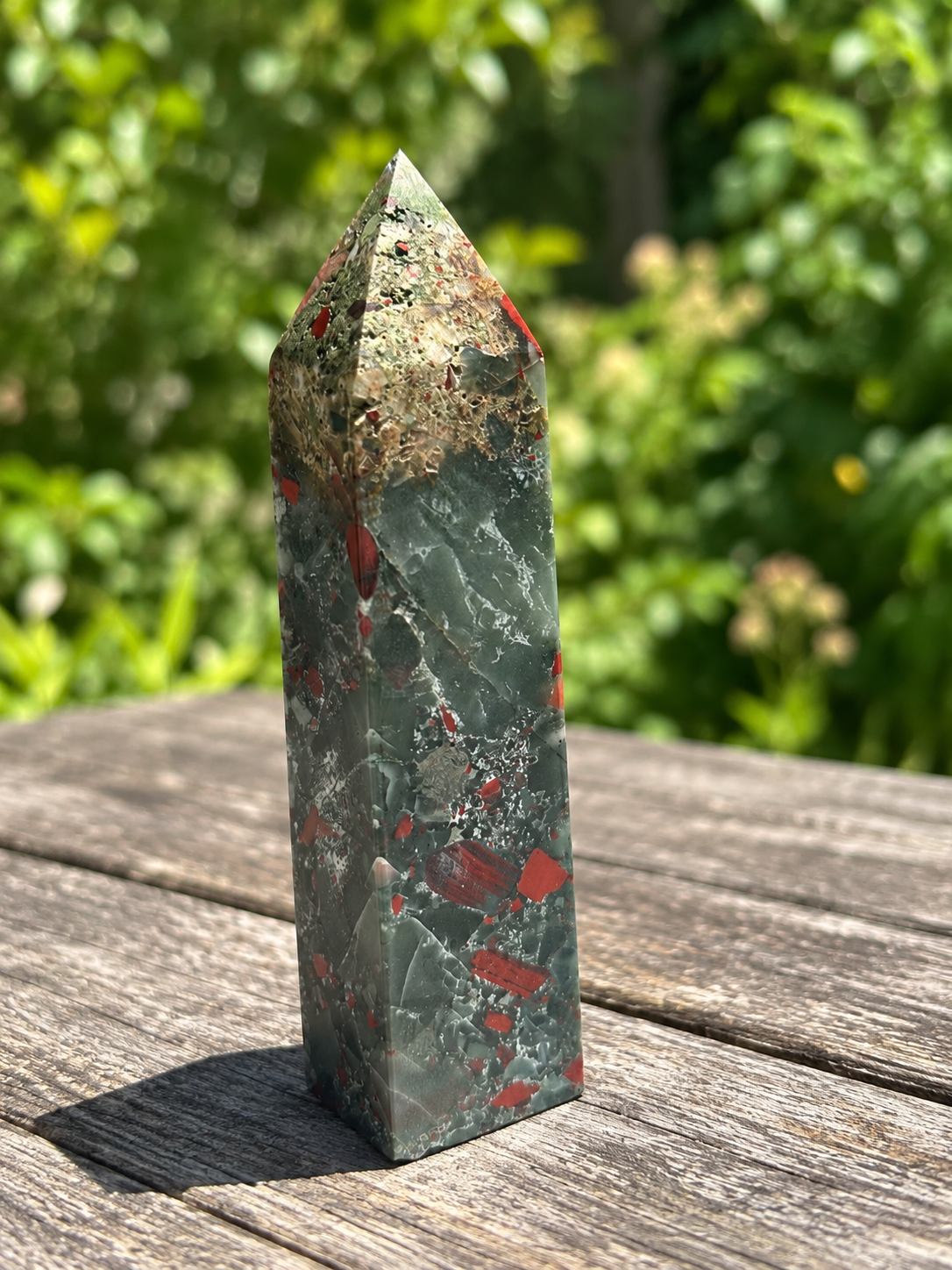 Reverse angle of exact 480g bloodstone tower No.3 showing pitted beige mineral texture near the top and red fragments below