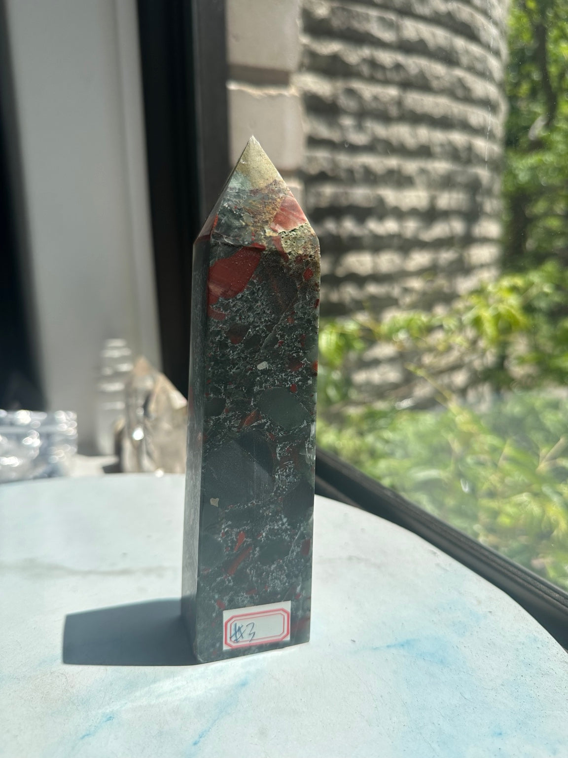 Unedited original front photograph of exact African bloodstone tower No.3 in window light, with its red number label