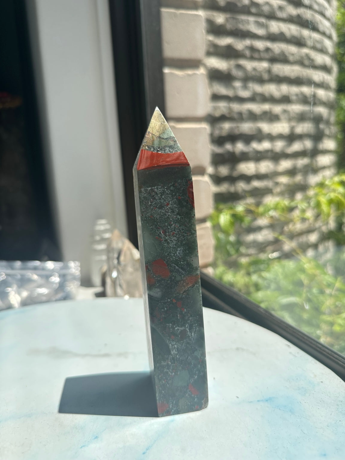 Unedited original side photograph of African bloodstone tower No.3 showing the red band, grey-green colour and surface detail