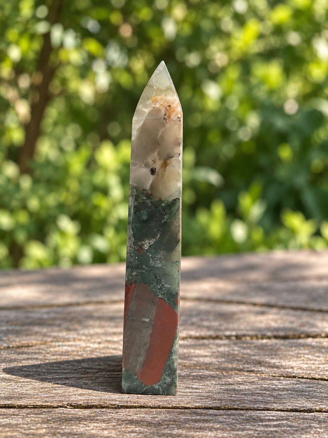 Narrow side of No.4 bloodstone tower showing the cream-grey point and a long muted brick-red patch near the lower half.