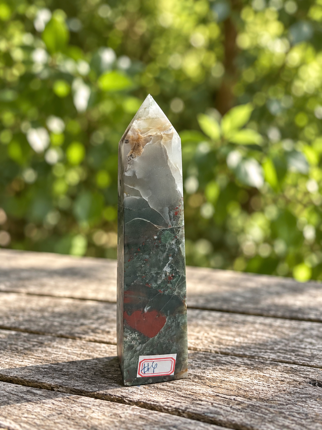 Front view of No.4 African bloodstone tower with its number label, cloudy pale upper section, curved red patch and fine natural surface lines.