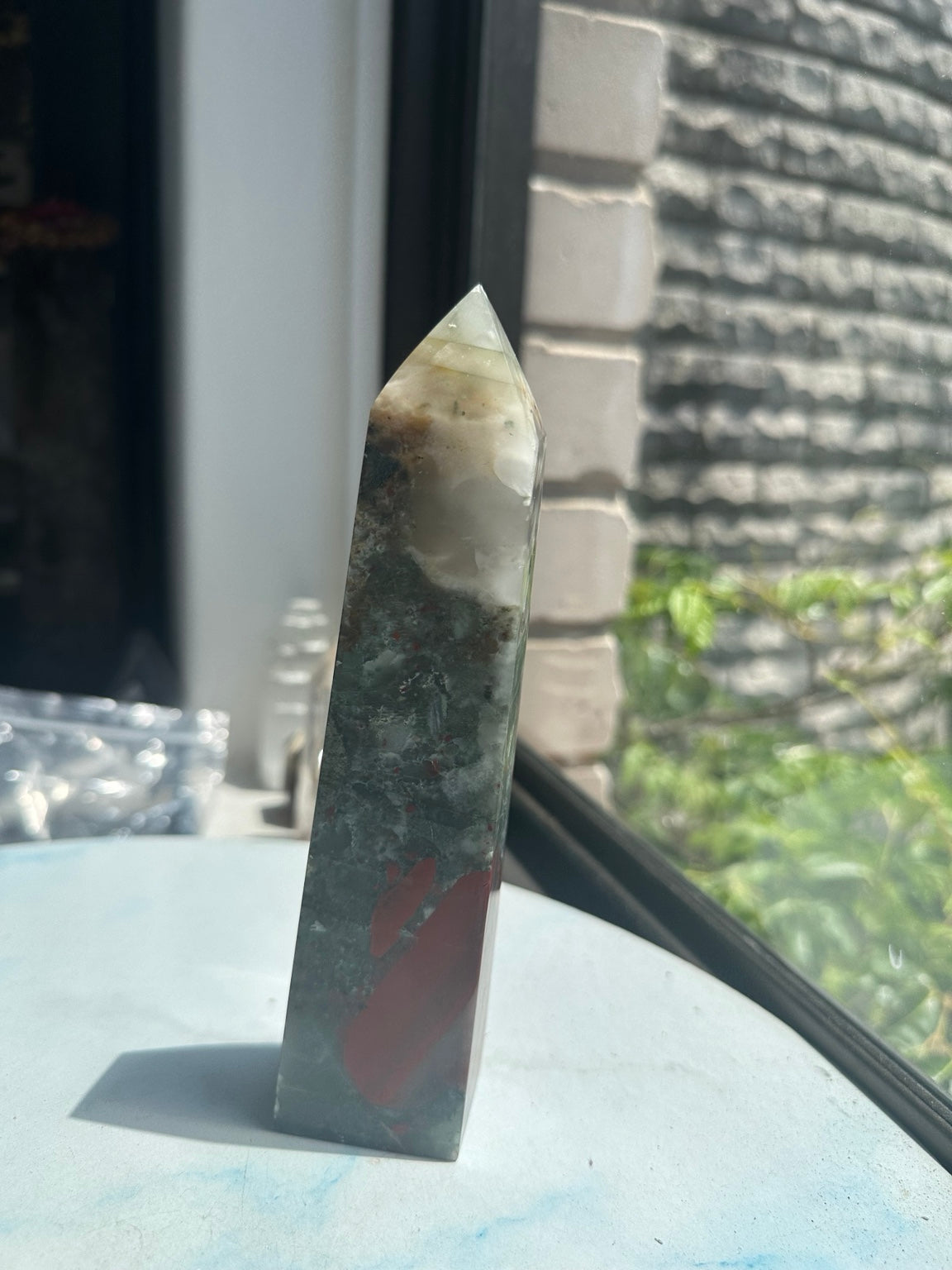 Unedited original reverse photograph of exact No.4 bloodstone tower showing long dusty-red patches, grey-green body and cloudy pale tip.