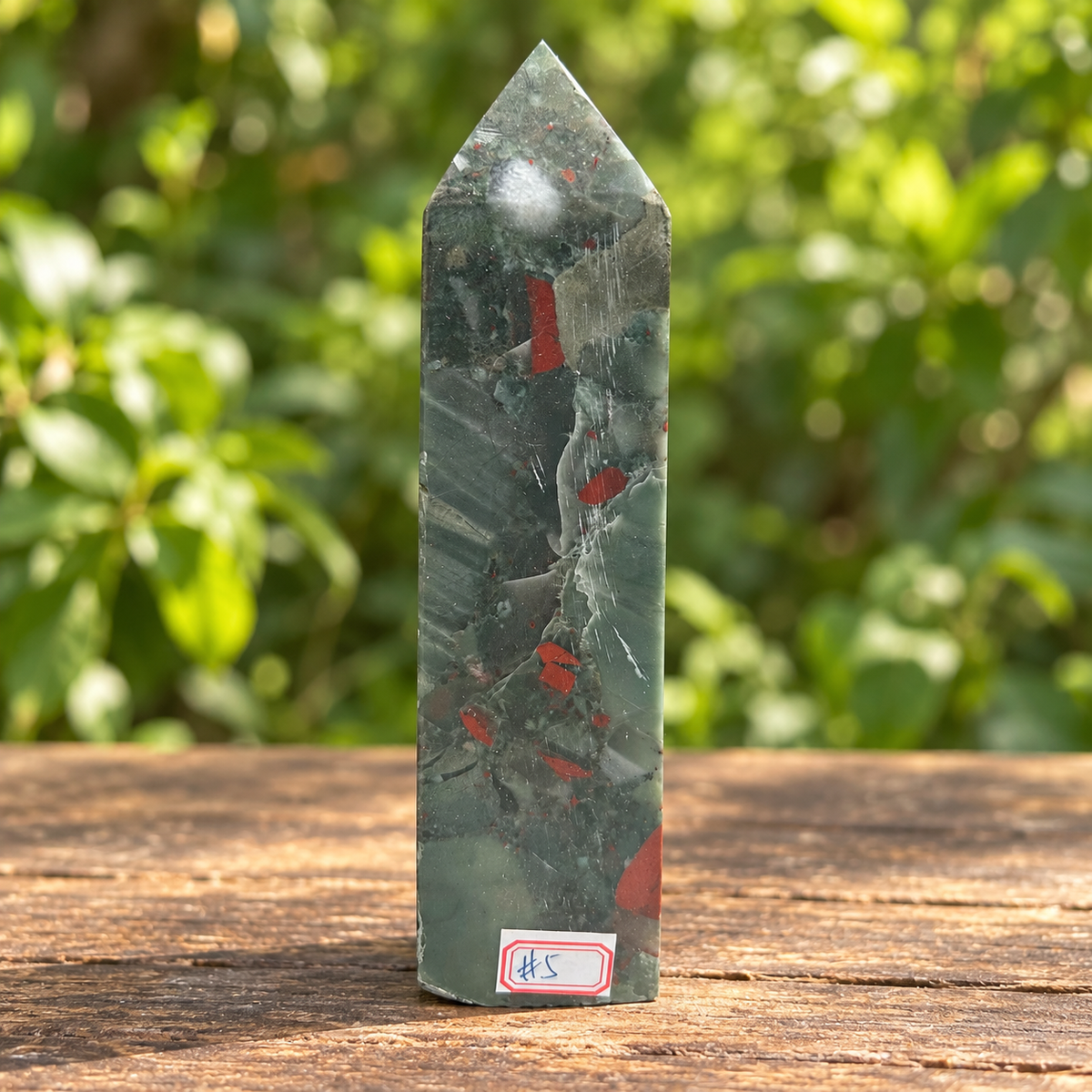 Full front view of No.5 bloodstone tower showing a narrow red marking below the point, smaller red fragments and visible polishing lines.