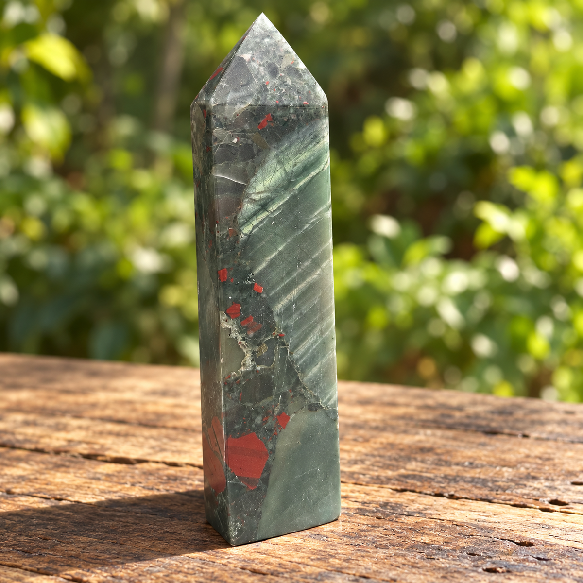Reverse view of No.5 bloodstone tower showing broad diagonal pale bands across grey-green stone and red markings near the base.
