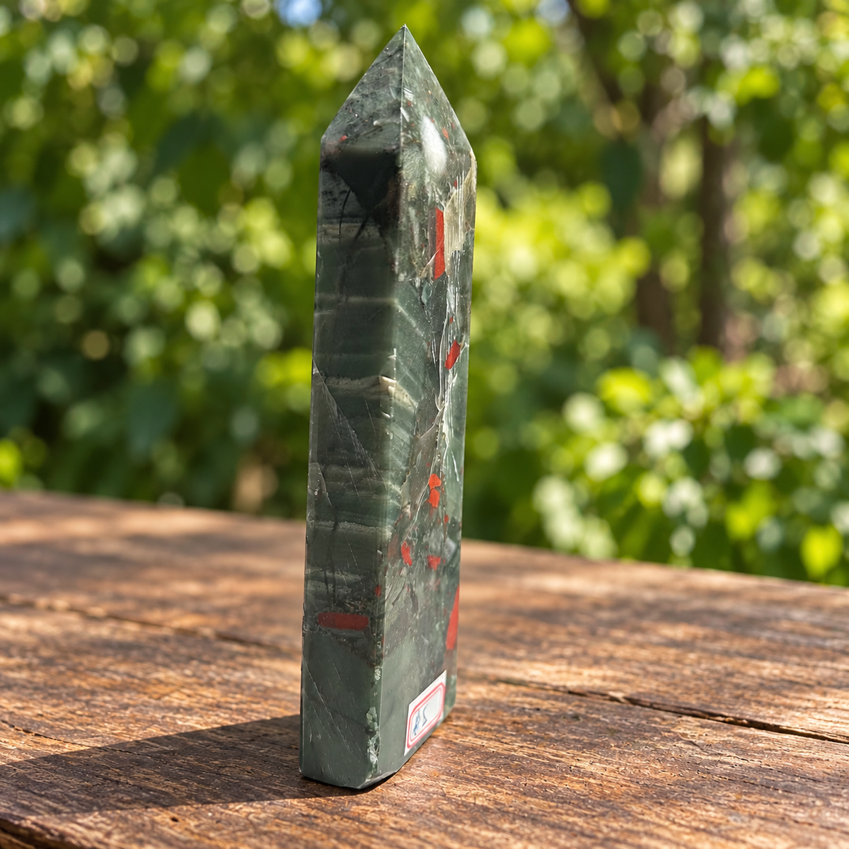 Three-quarter side of No.5 African bloodstone tower showing the pointed facets and red fragments on adjoining faces.