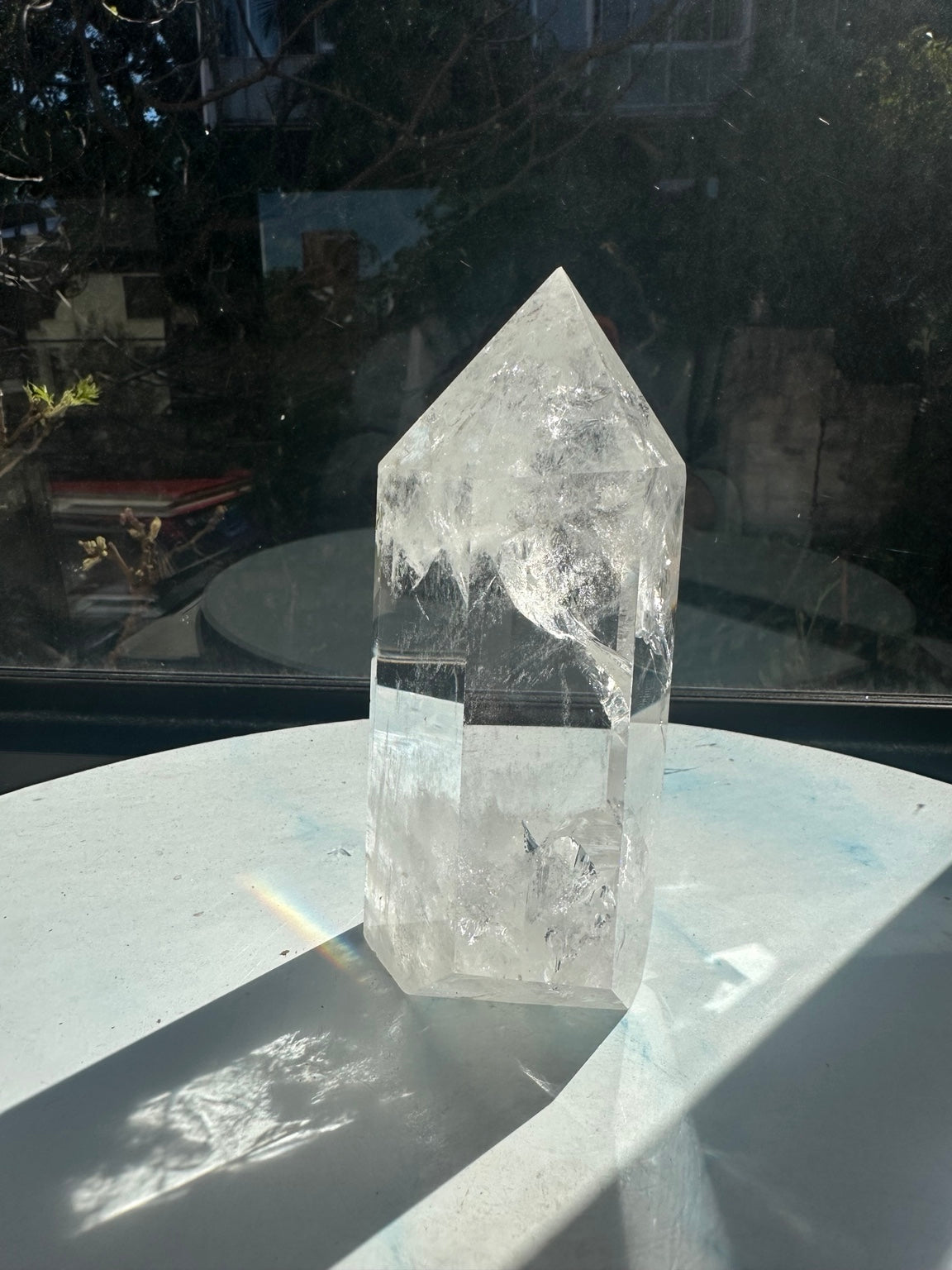 Another side of tower #2 showing its pointed top, transparent middle, milky base and a narrow rainbow light patch beside the crystal.