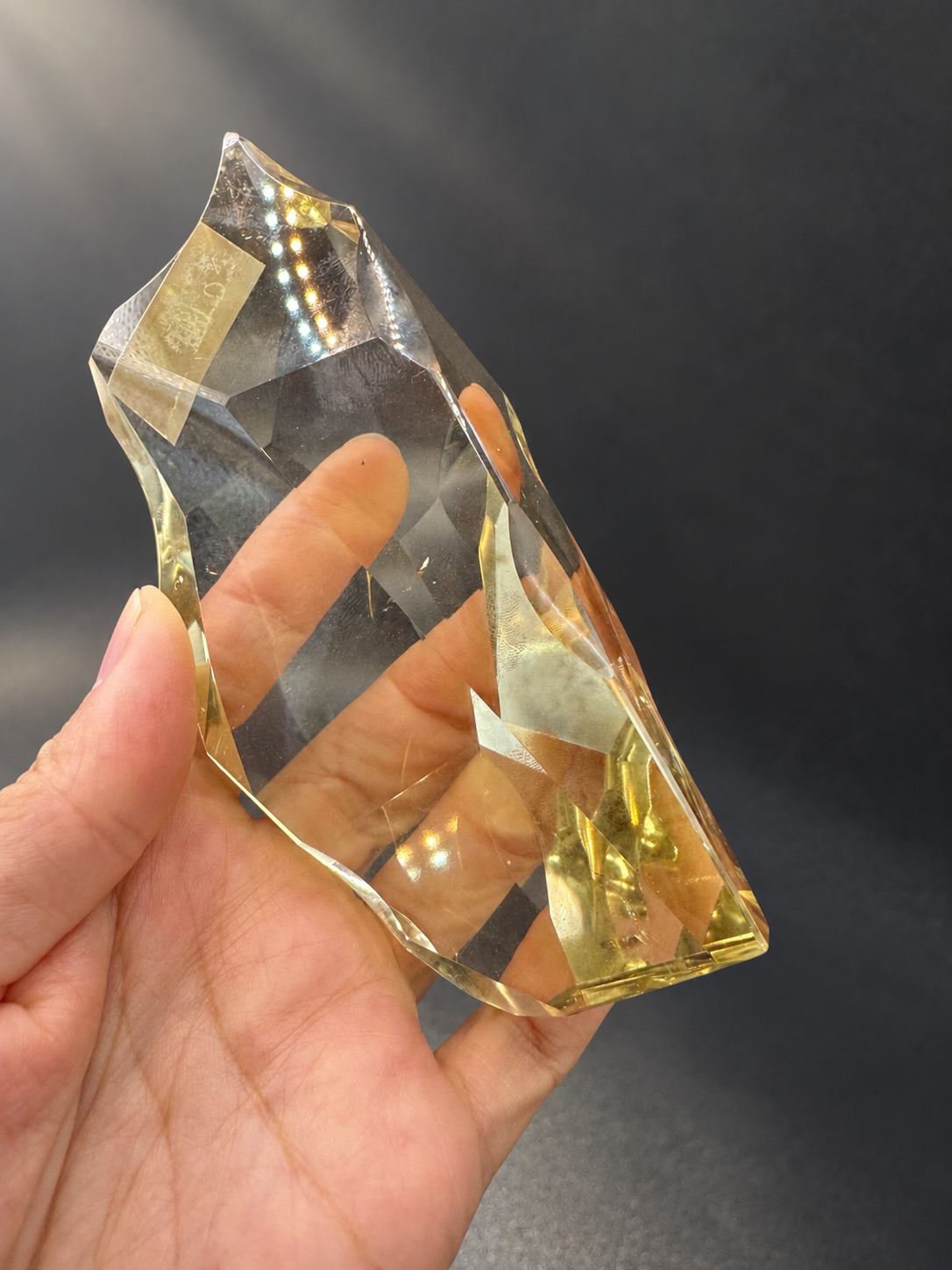 Fine-cut Brazilian citrine No.10 showing its curved freeform top and pale golden edges