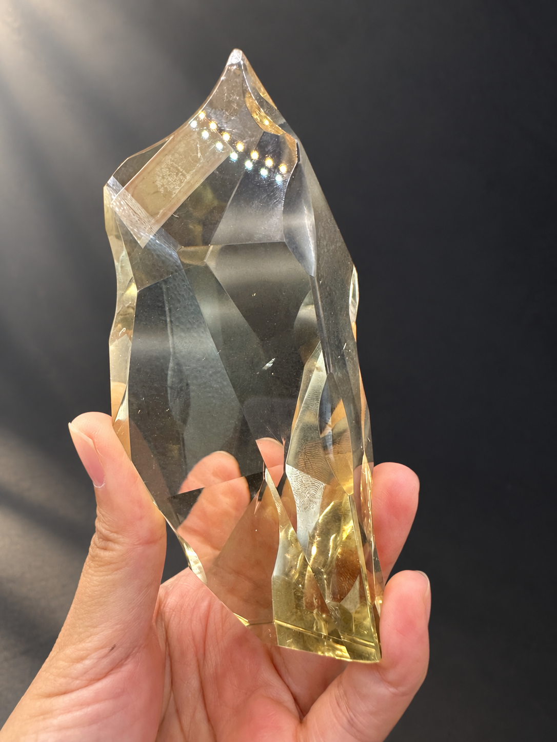 Brazilian citrine freeform No.10, 12cm tall, alternate faceted face in hand