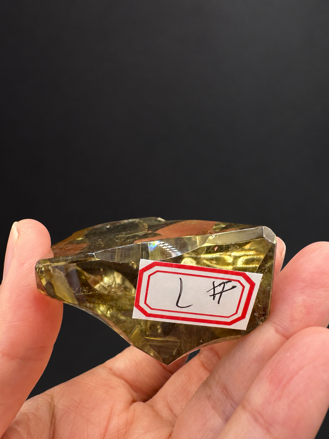 Brazilian citrine freeform No.7, 117g, approx. 7 × 5cm; labelled No.7 lower profile showing the base, depth and natural internal details, held in the original hand against a charcoal background.