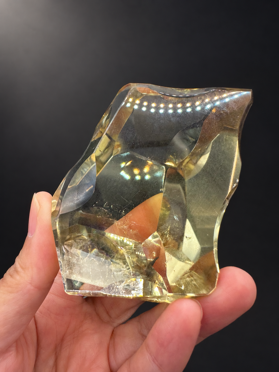 Broad faceted face of Brazilian citrine No.9 with real reflections and base inclusions