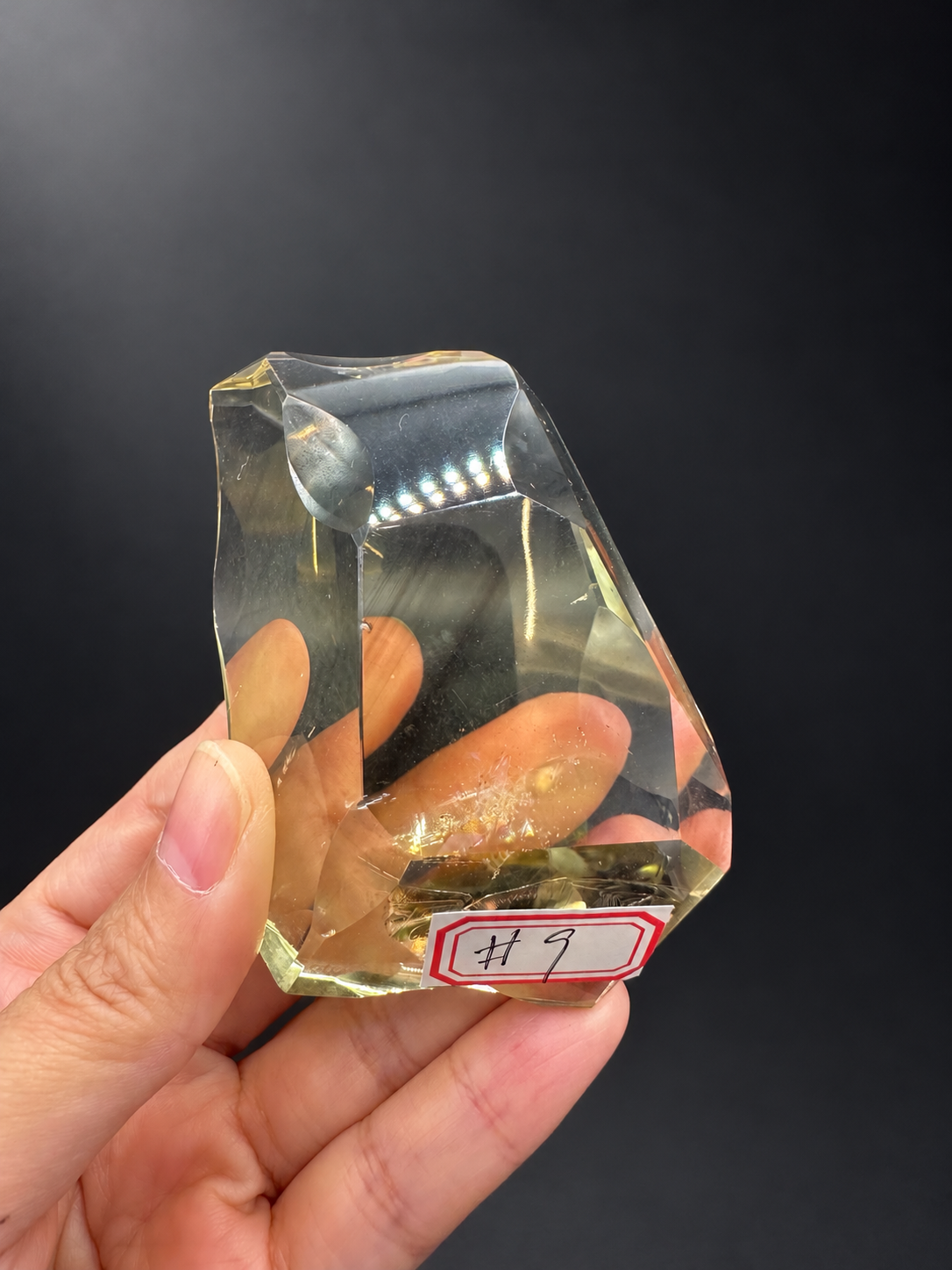 Brazilian citrine freeform No.9 with original number sticker, held in hand