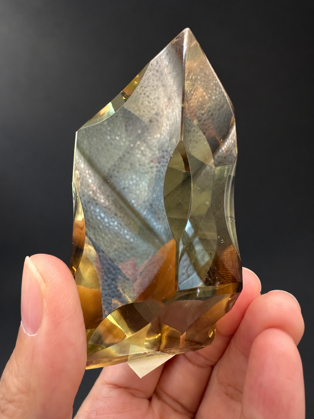 Brazilian citrine freeform No.2, 190g, approximately 8 × 4.4cm; opposite upright face with a sharply sloping top and original textured light reflections, held in the original hand.