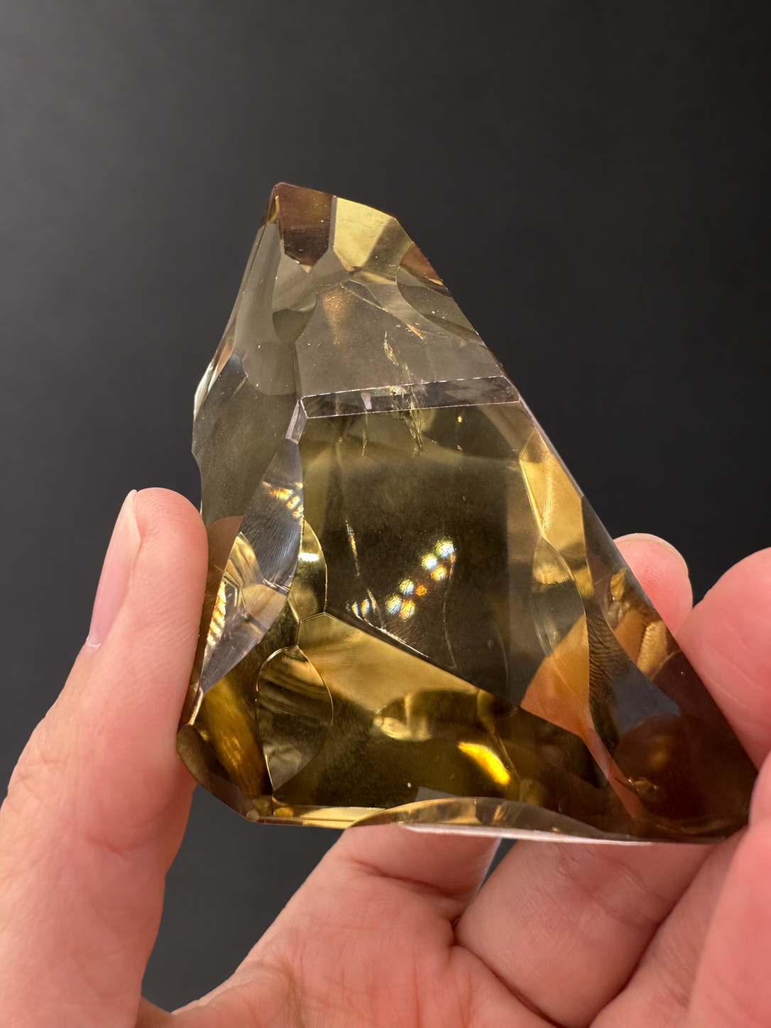Brazilian citrine freeform No.2, 190g, approximately 8 × 4.4cm; opposite end detail showing golden internal reflections and small visible lines, held in the original hand.