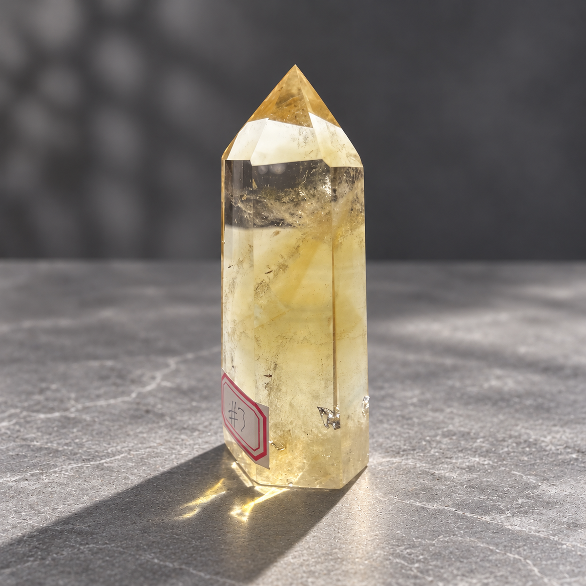 Brazilian citrine tower #3, opposite side showing polished facets, natural inclusions and internal veils