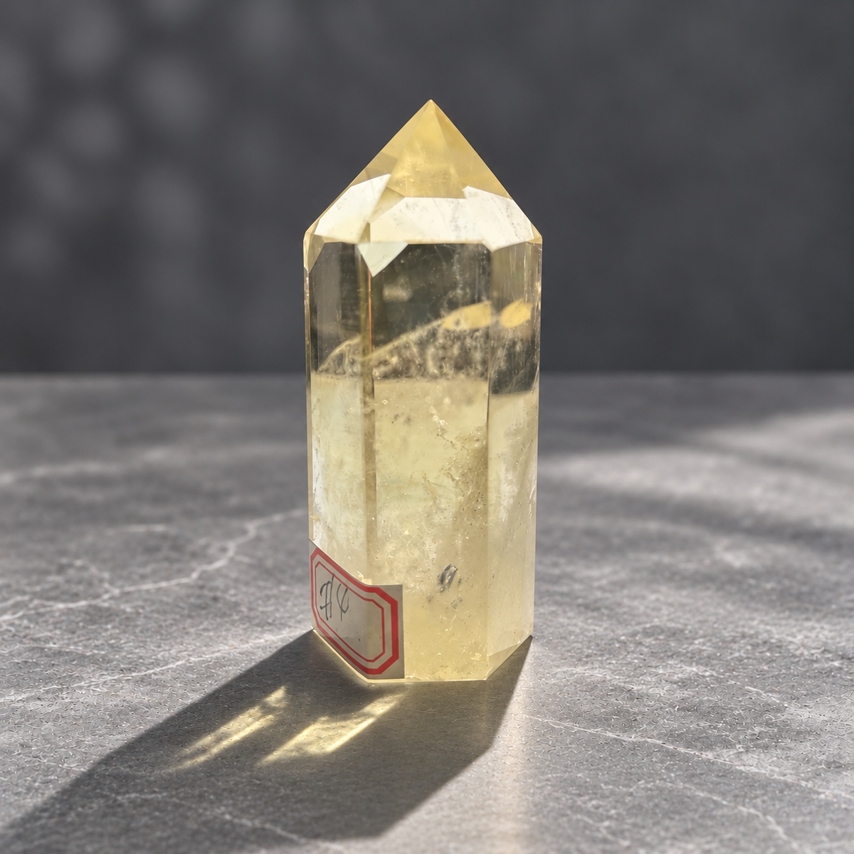 Side angle of Brazilian citrine tower #4 showing its polished facets and internal inclusions