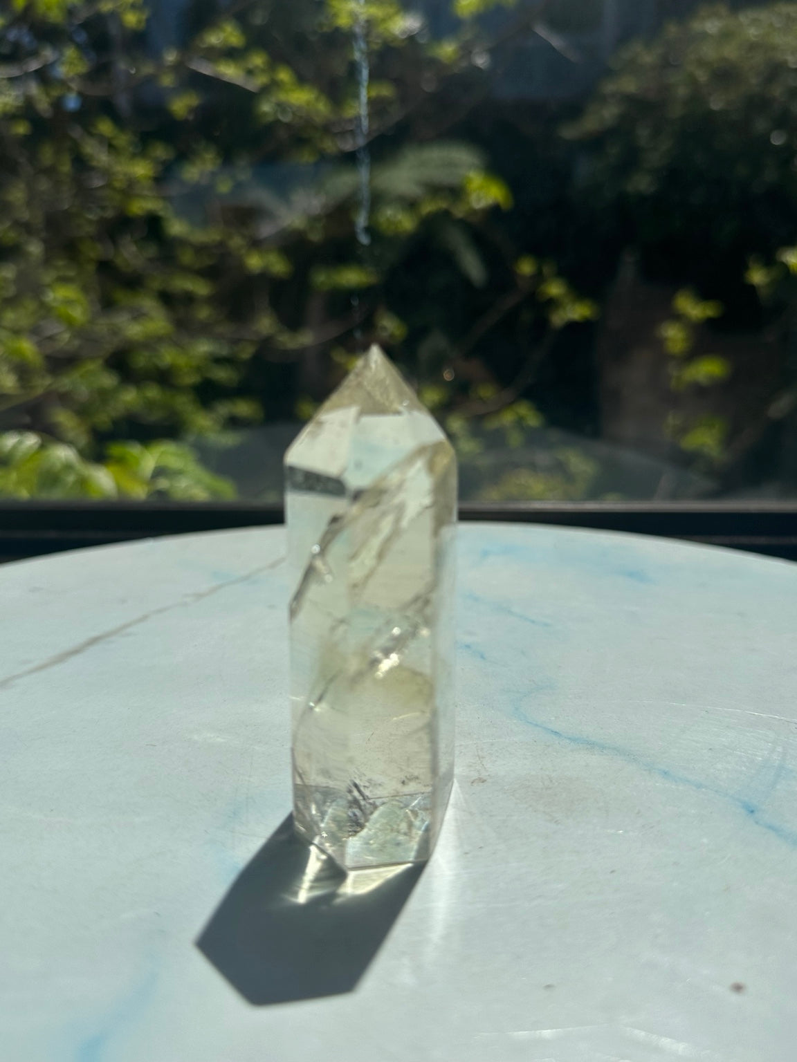 Original sunlight side photograph of exact Brazilian pale yellow champagne citrine tower #6, showing its very light colour and natural internal fractures