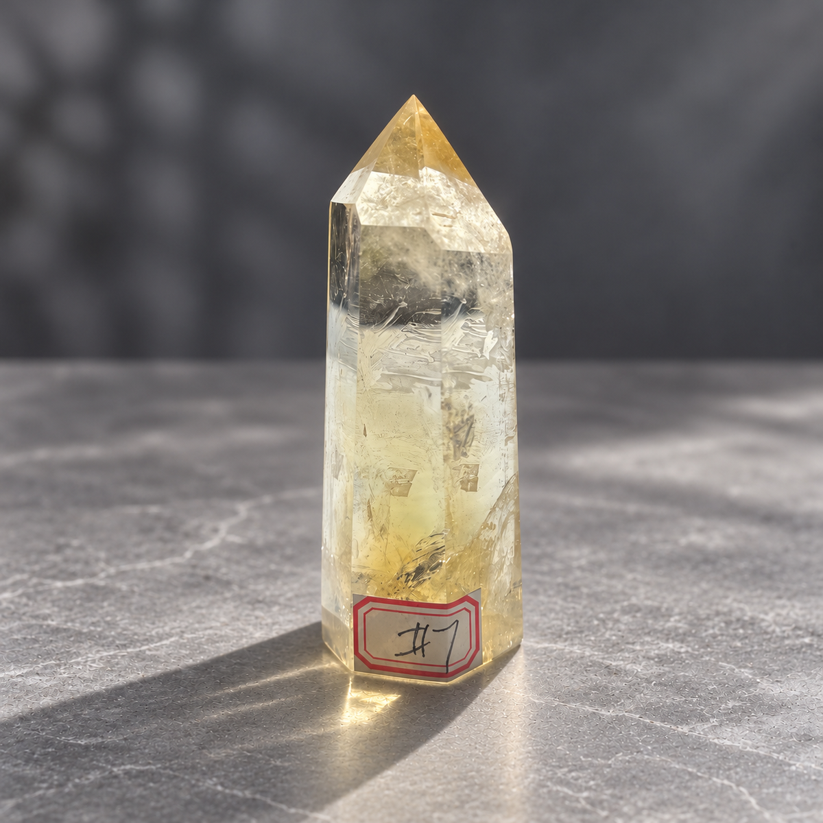 Front view of Brazilian citrine tower #7 with original handwritten number label and rippled natural veils