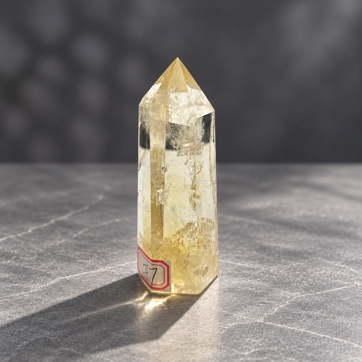 Angled front of pale champagne citrine tower #7 showing long polished facets and clear windows