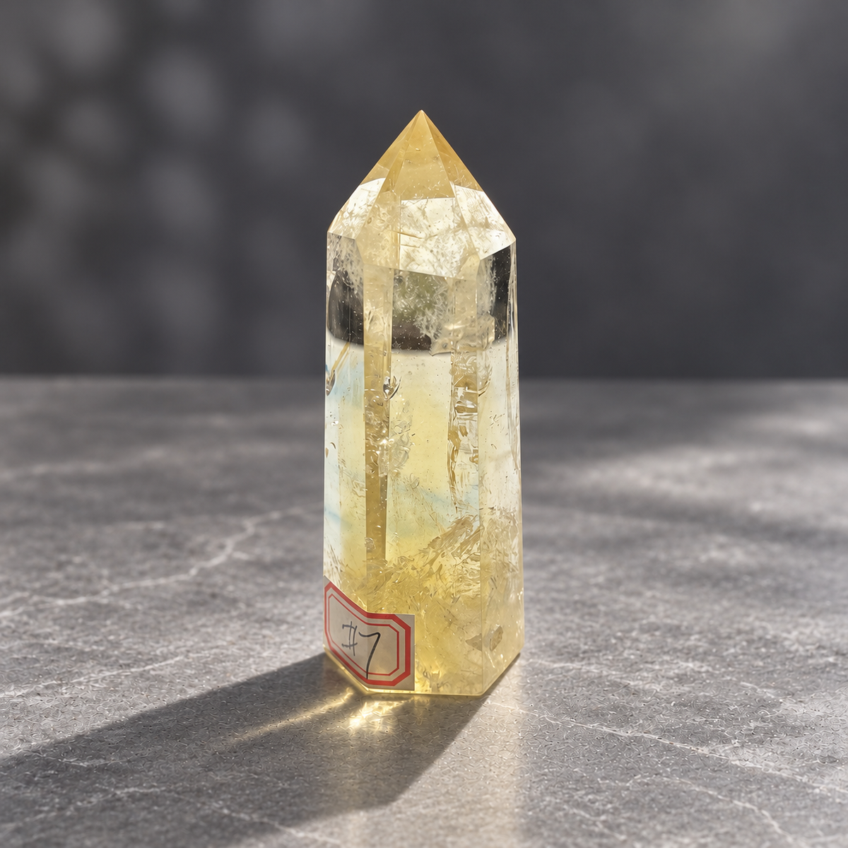 Angled front of Brazilian citrine tower #7, slender 9.8cm polished point with champagne colour
