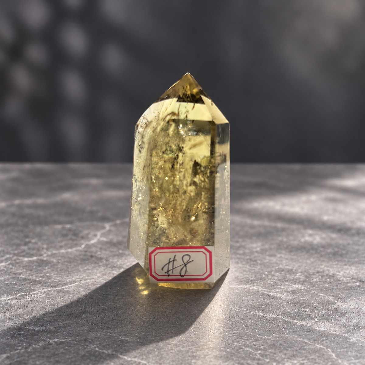 Brazilian pale yellow champagne citrine tower #8, 164g. Front view with original number 8 label, pale champagne colour and dense reflective internal veils