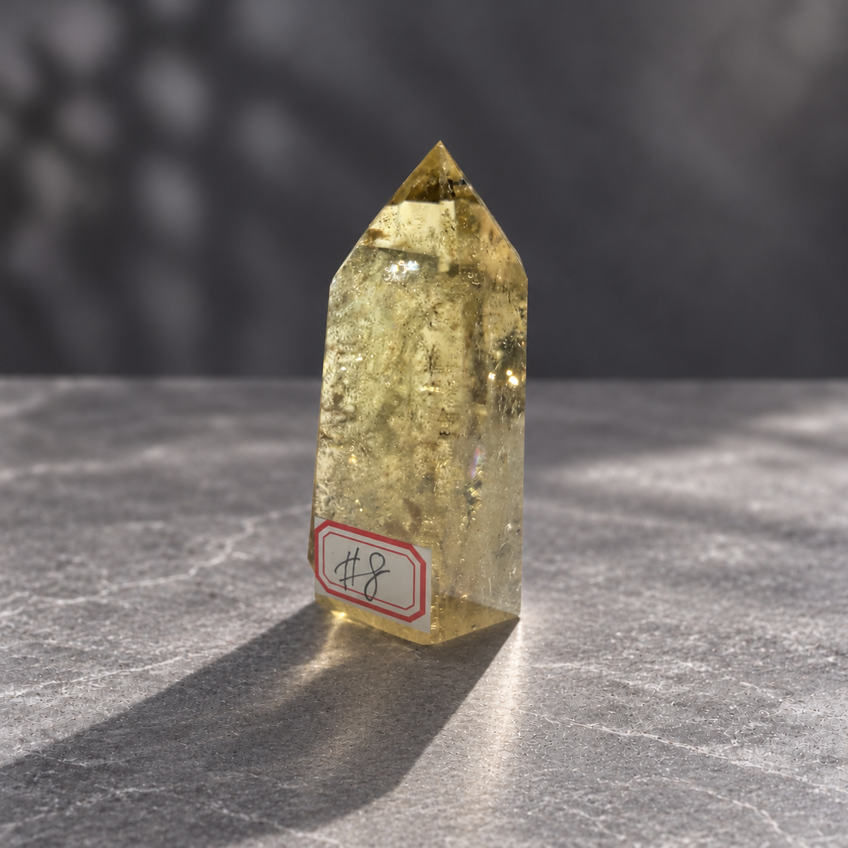 Brazilian pale yellow champagne citrine tower #8, 164g. Angled front showing polished facets and fine natural inclusions