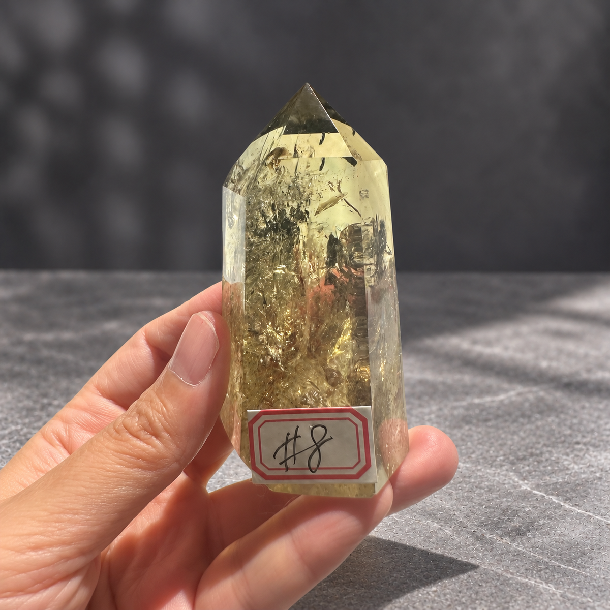 Brazilian pale yellow champagne citrine tower #8, 164g. Hand-held view showing the real scale of tower 8 and its internal layers