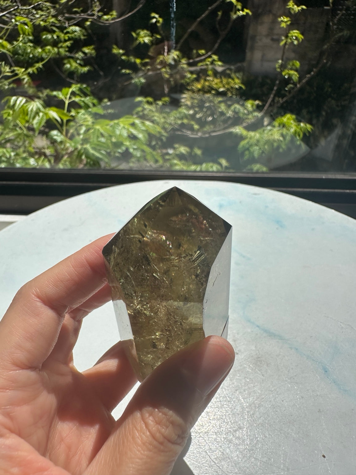 Brazilian pale yellow champagne citrine tower #8, 164g. Original sunlight hand-held detail showing the real rainbow flashes within tower 8