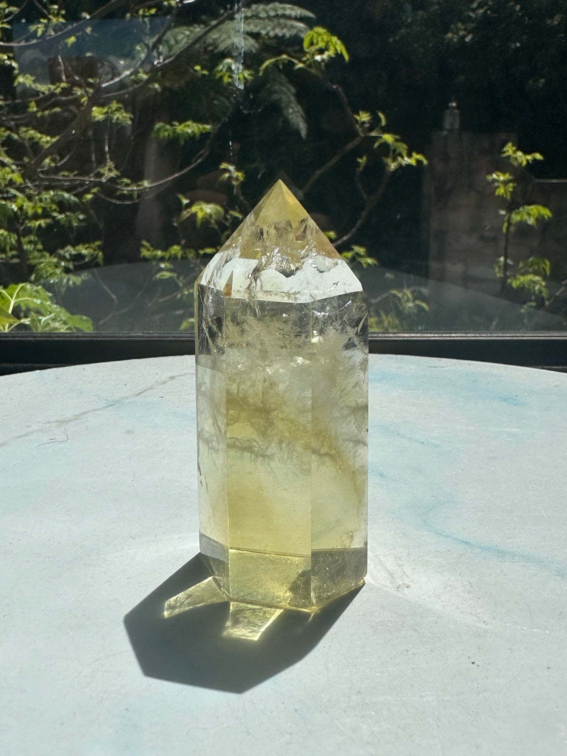 Original natural-sunlight photograph of Brazilian citrine tower #1, 150g, showing actual colour, internal inclusions and faceted shape