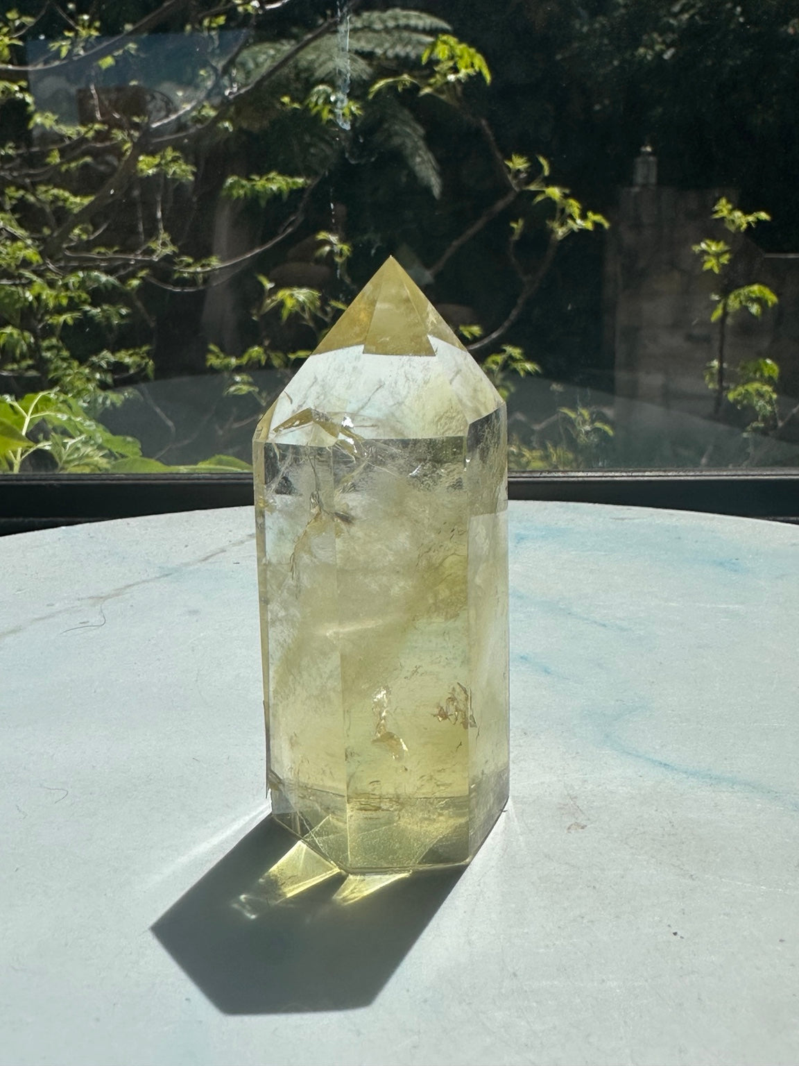 Original natural-sunlight photograph of Brazilian citrine tower #1, 150g, showing actual colour, internal inclusions and faceted shape
