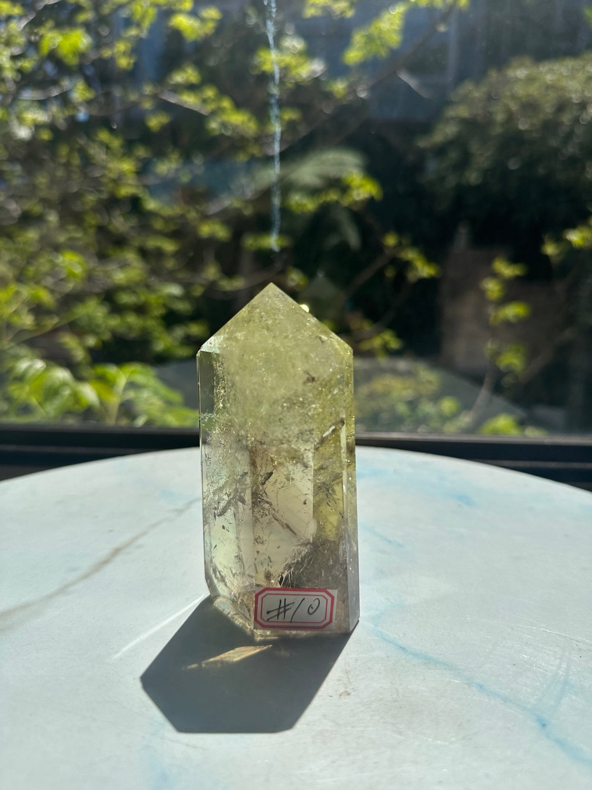 Original sunlight photograph 1 of exact Brazilian citrine tower #10, pale yellow champagne quartz showing natural fine veils, darker internal planes and polished facets.