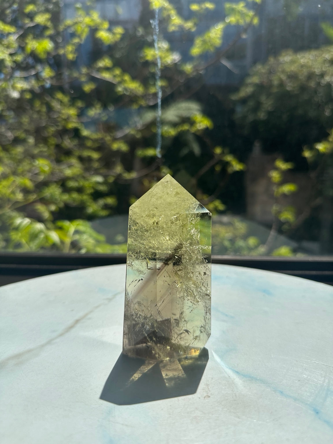 Original sunlight photograph 2 of exact Brazilian citrine tower #10, pale yellow champagne quartz showing natural fine veils, darker internal planes and polished facets.