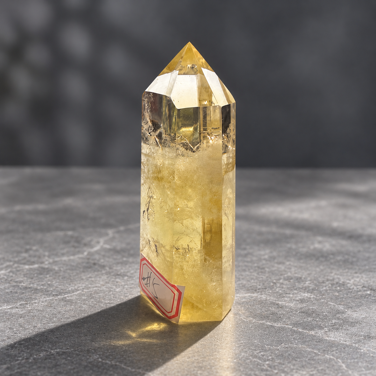 Brazilian citrine tower #5, angled front showing polished facets and a narrow golden side