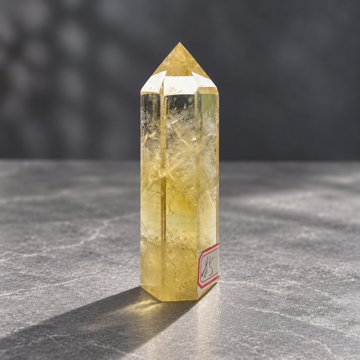 Brazilian citrine tower #5, opposite angled view with its identifying label and golden lower body