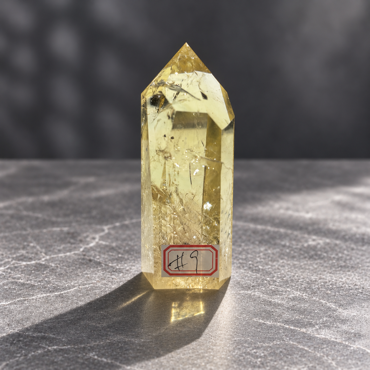 Brazilian citrine tower #9, 228g pale yellow champagne crystal point; polished specimen angle 2 with reflective internal veils and subtle darker inclusions. Exact piece photographed.