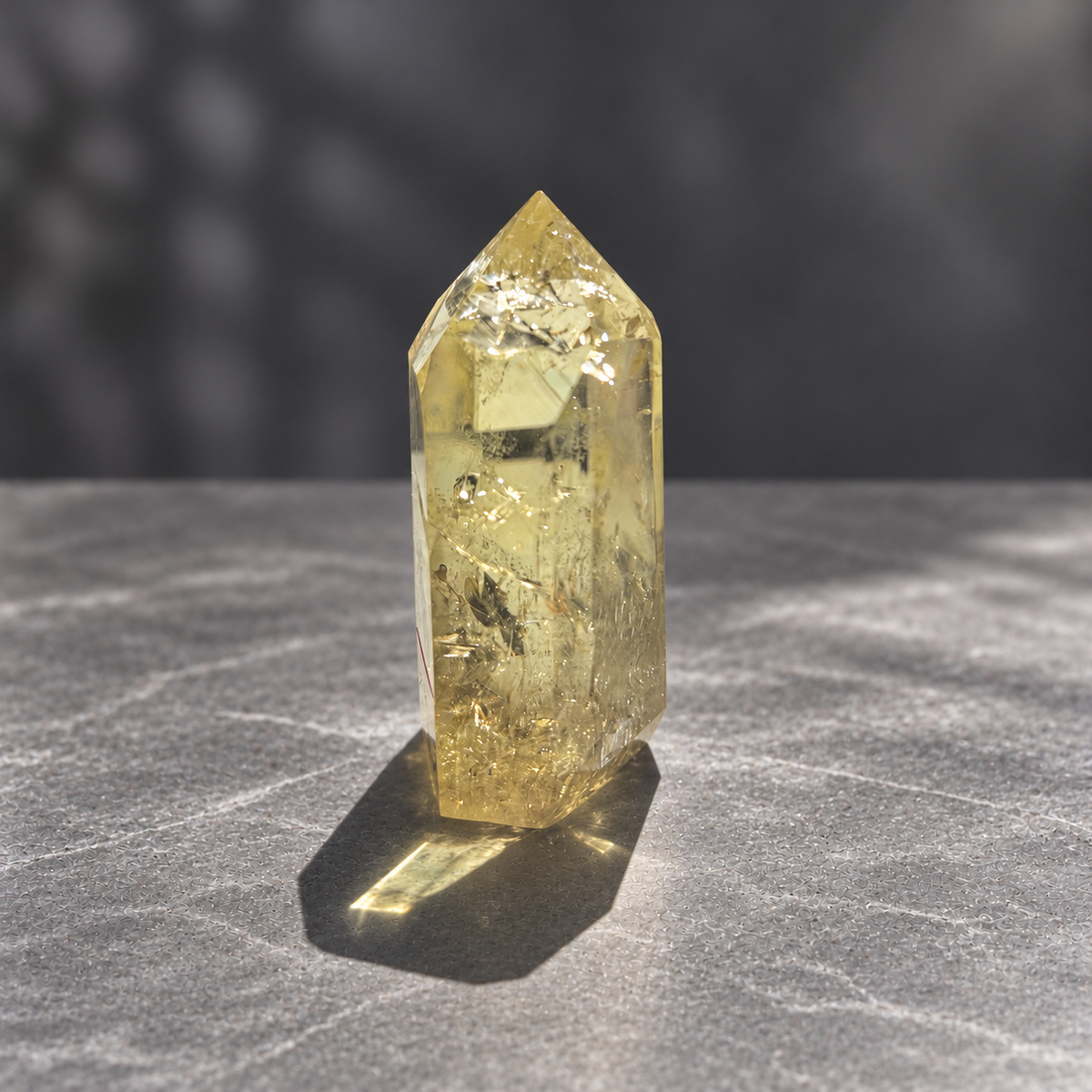 Brazilian citrine tower #9, 228g pale yellow champagne crystal point; polished specimen angle 4 with reflective internal veils and subtle darker inclusions. Exact piece photographed.