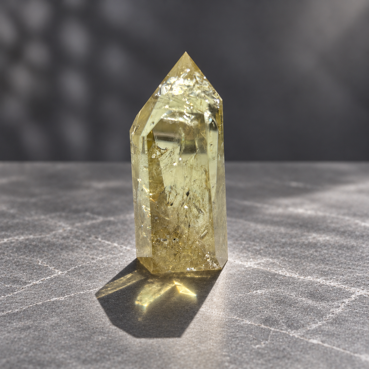 Brazilian citrine tower #9, 228g pale yellow champagne crystal point; polished specimen angle 5 with reflective internal veils and subtle darker inclusions. Exact piece photographed.