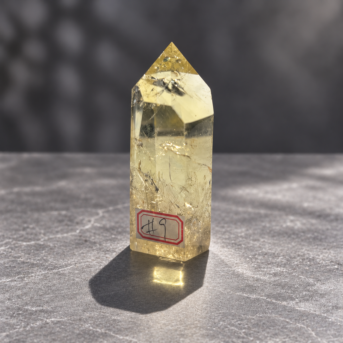 Brazilian citrine tower #9, 228g pale yellow champagne crystal point; polished specimen angle 9 with reflective internal veils and subtle darker inclusions. Exact piece photographed.