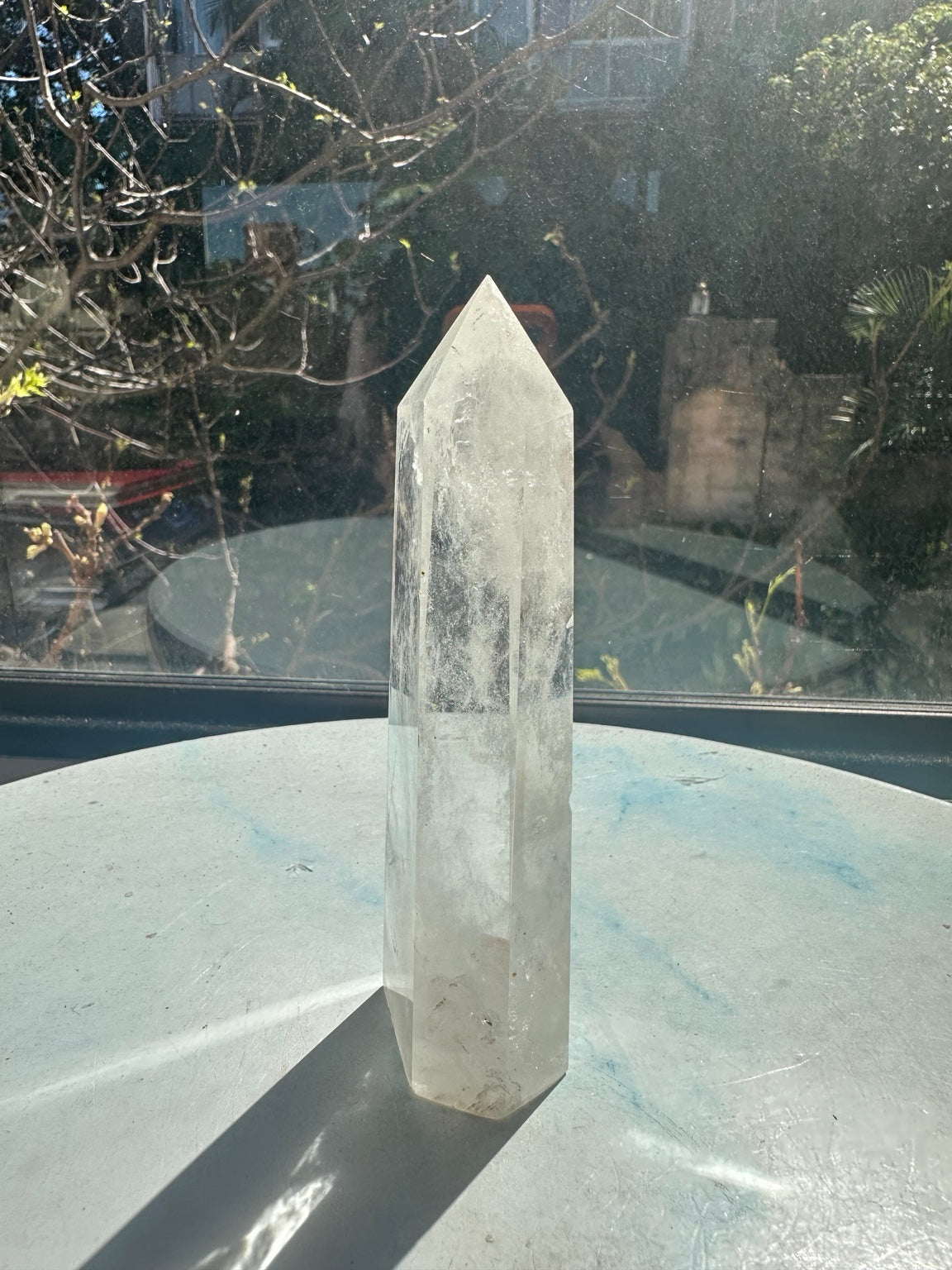 Brazilian clear quartz tower number 8, 232g and 13.2cm tall: unlabelled side showing polished edges and a cloudy lower section.