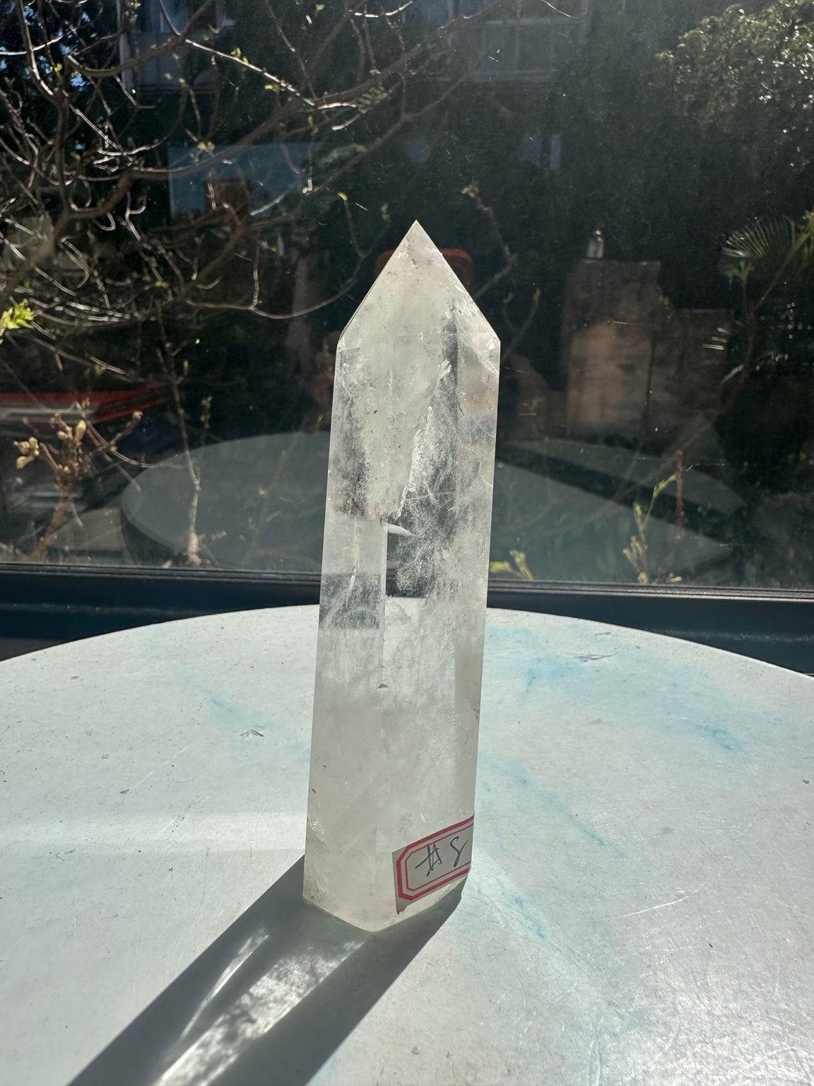 Brazilian clear quartz tower number 8, 232g and 13.2cm tall: angled side with the identifying label at the lower right.