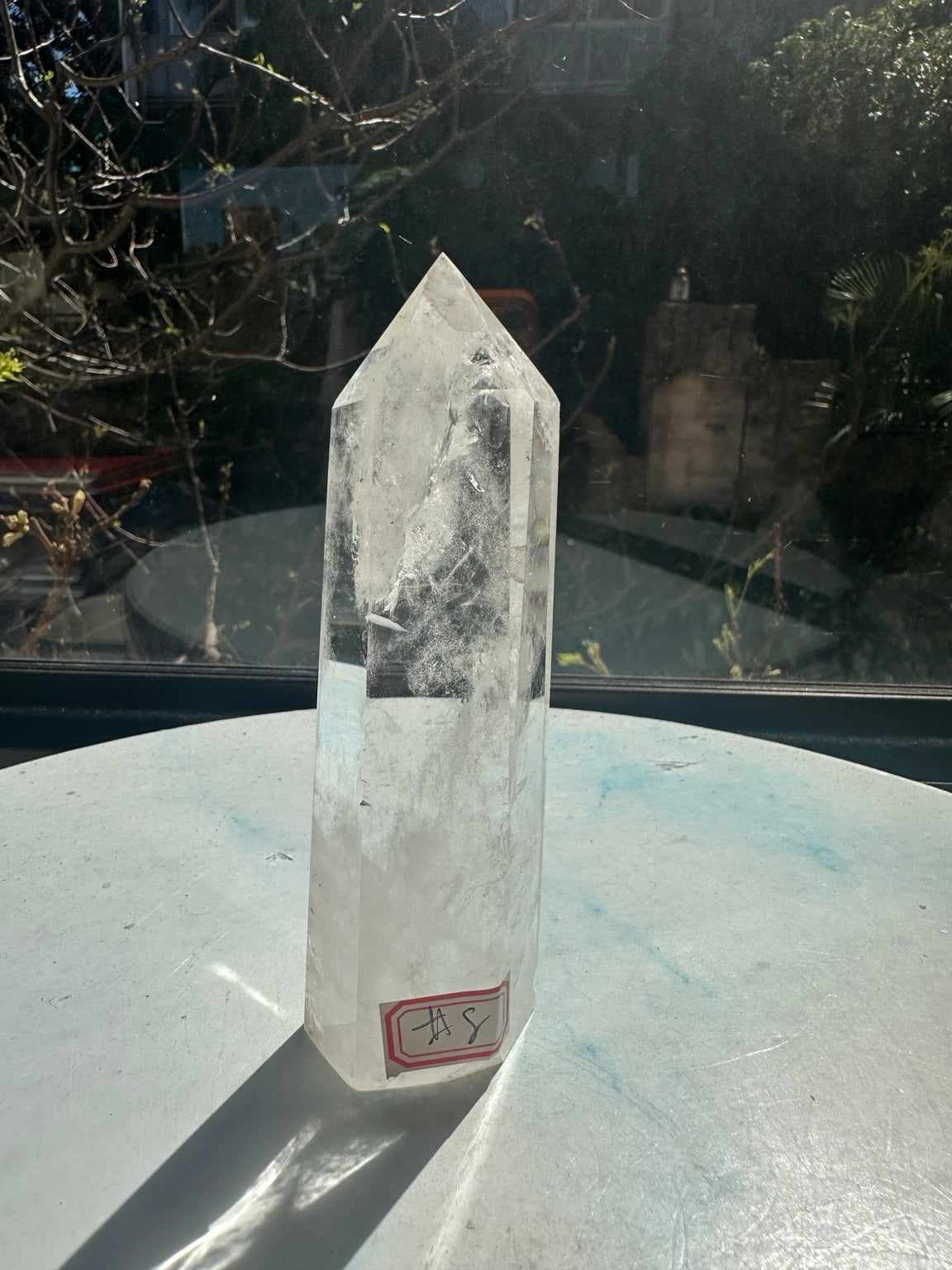 Brazilian clear quartz tower number 8, 232g and 13.2cm tall: front angled view showing broad clear windows and white internal fractures.