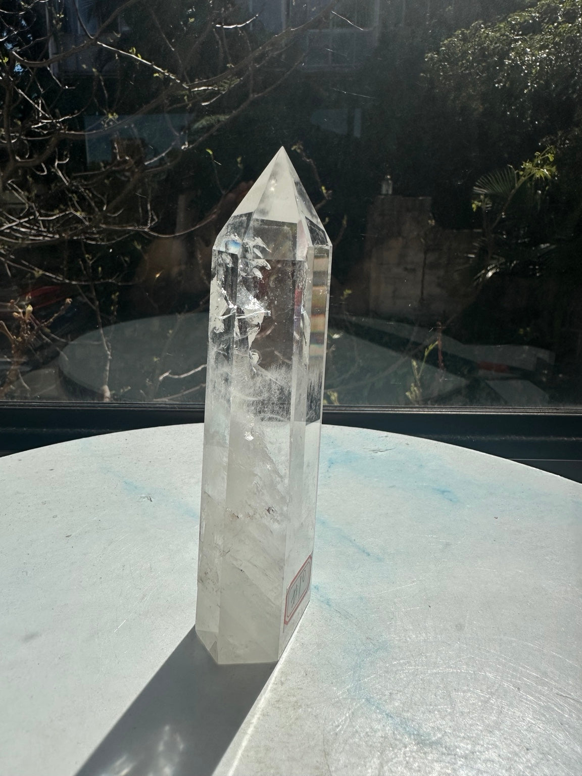 Brazilian clear quartz tower number 10, 280g and 14cm tall: opposite angled side showing polished edges and fine internal textures.