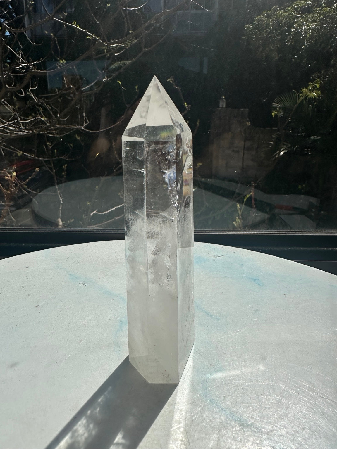Brazilian clear quartz tower number 10, 280g and 14cm tall: three-quarter side showing a pointed top and delicate internal lines.