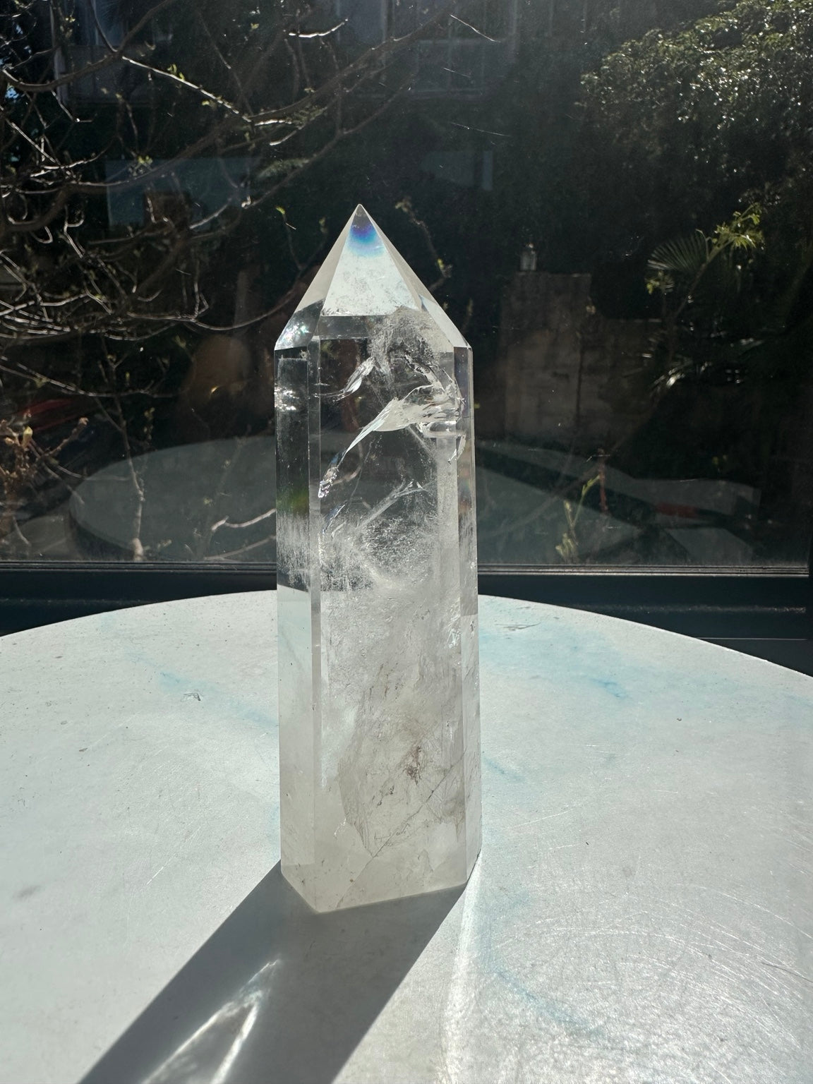 Brazilian clear quartz tower number 10, 280g and 14cm tall: unlabelled side showing transparent upper sections and white internal fractures.