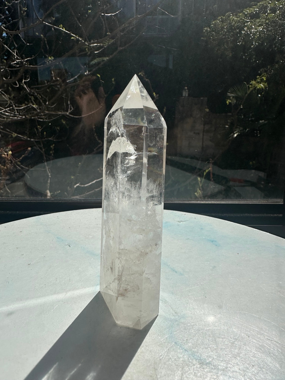 Brazilian clear quartz tower number 10, 280g and 14cm tall: reverse angled view showing its flat base and naturally cloudy lower section.